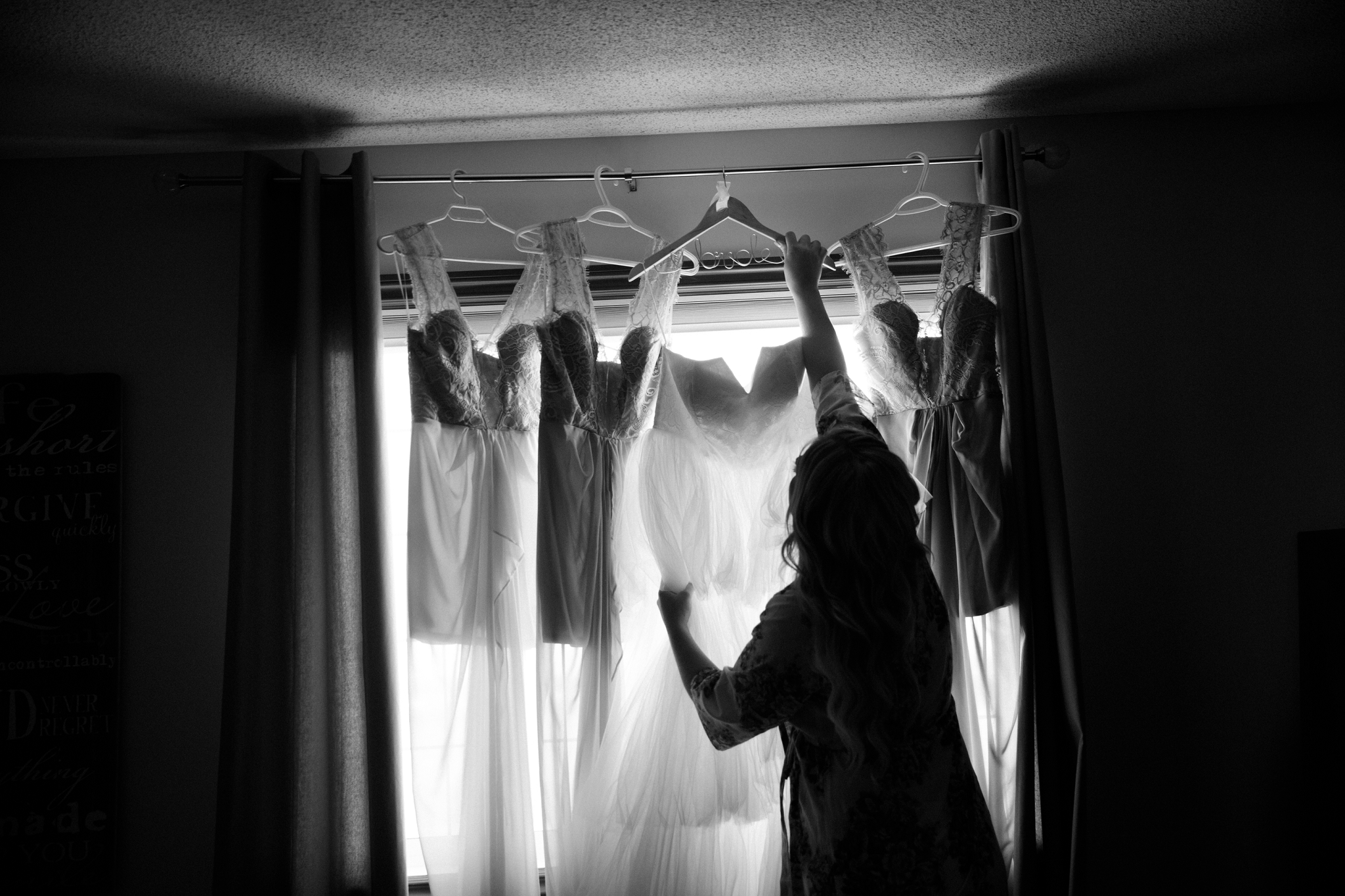 bride hanging wedding dress